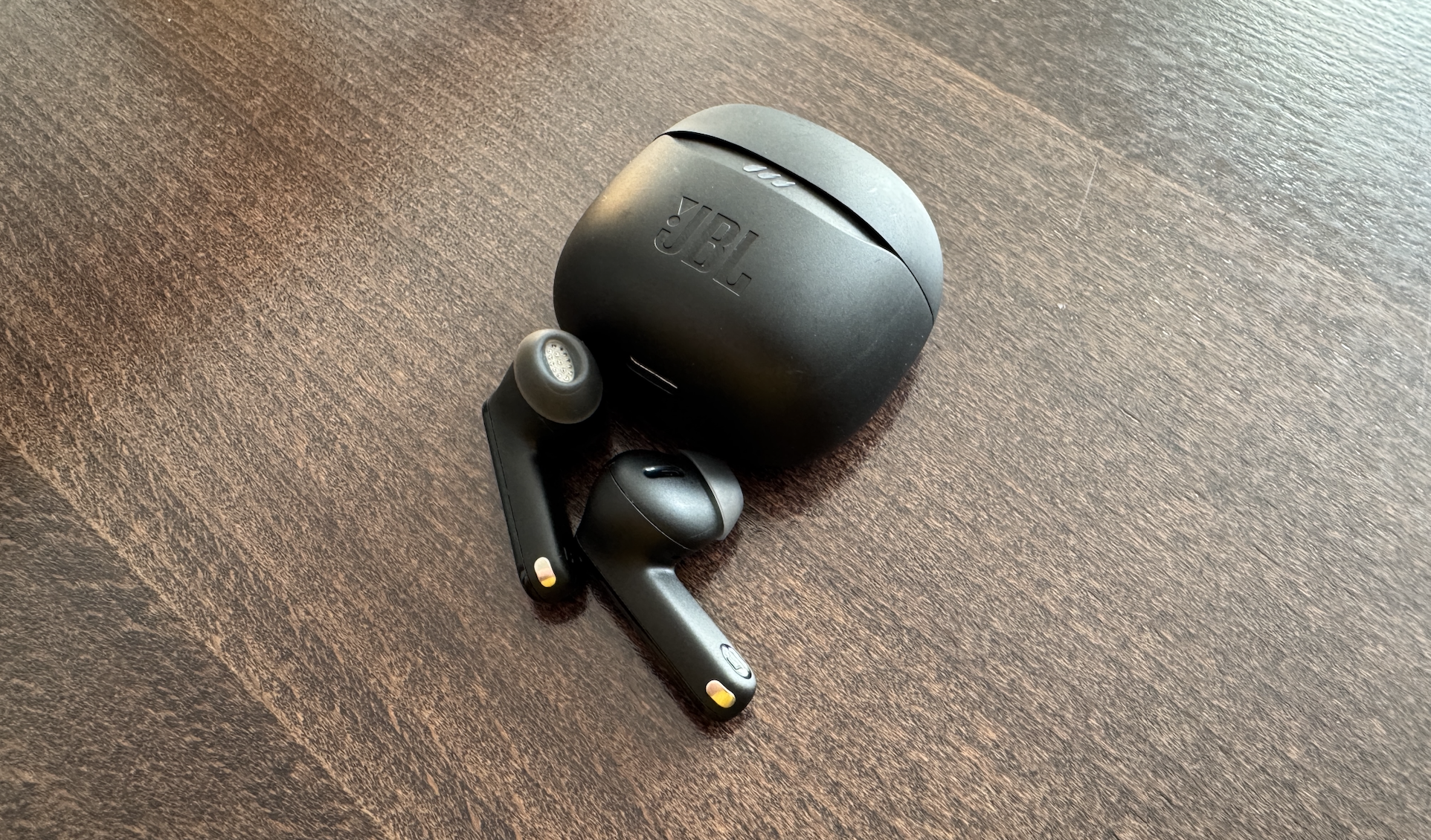 black wireless earbuds on table