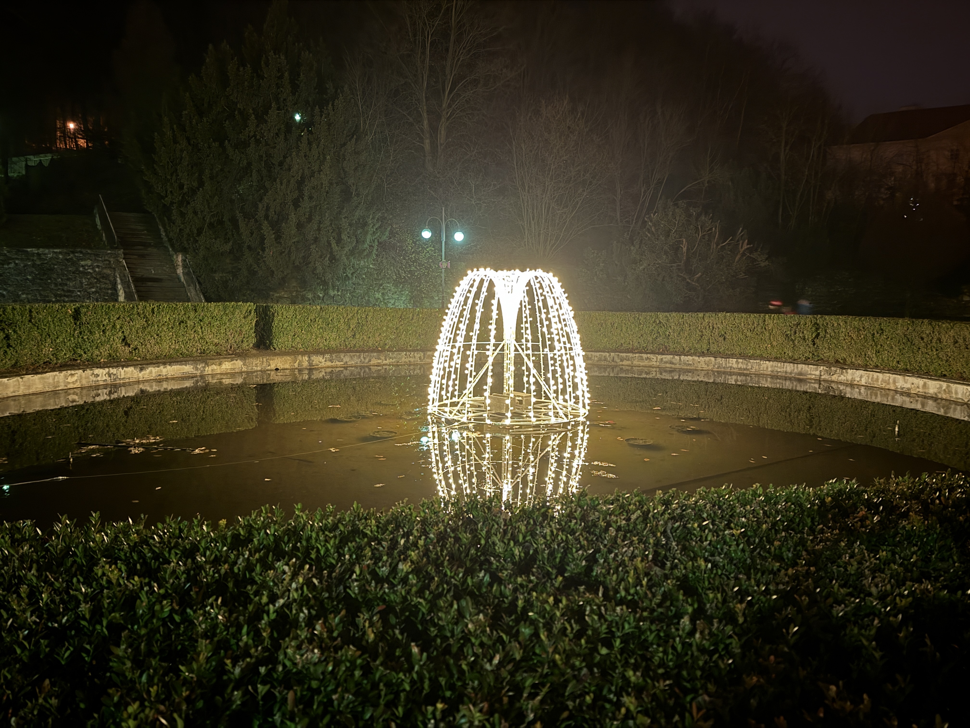 lit fountain garden night