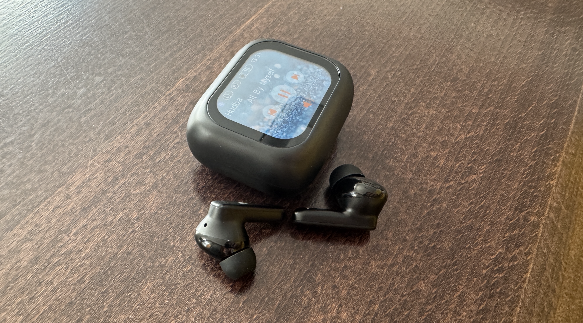 smartwatch and earbuds on table