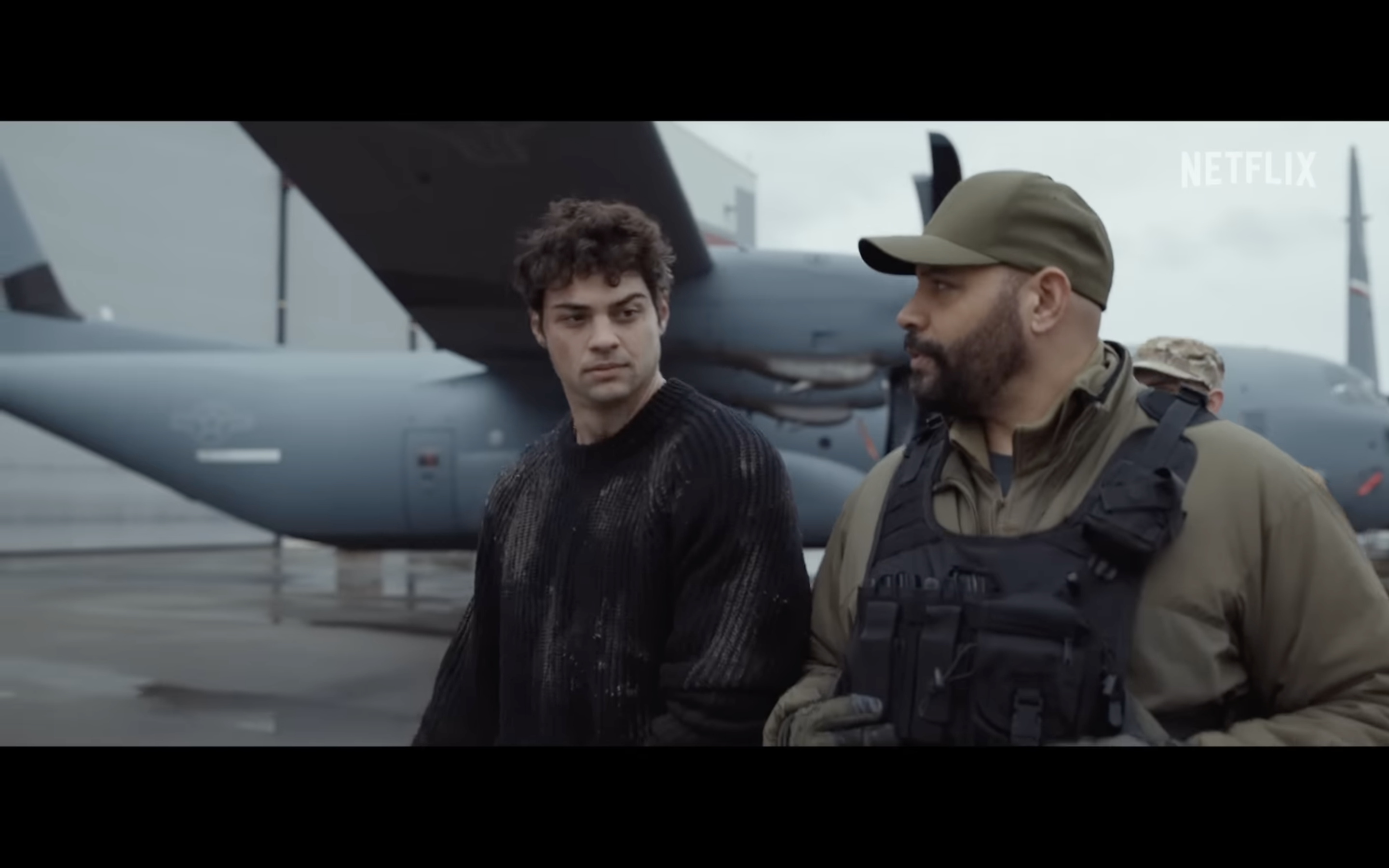 two men talking near airplane