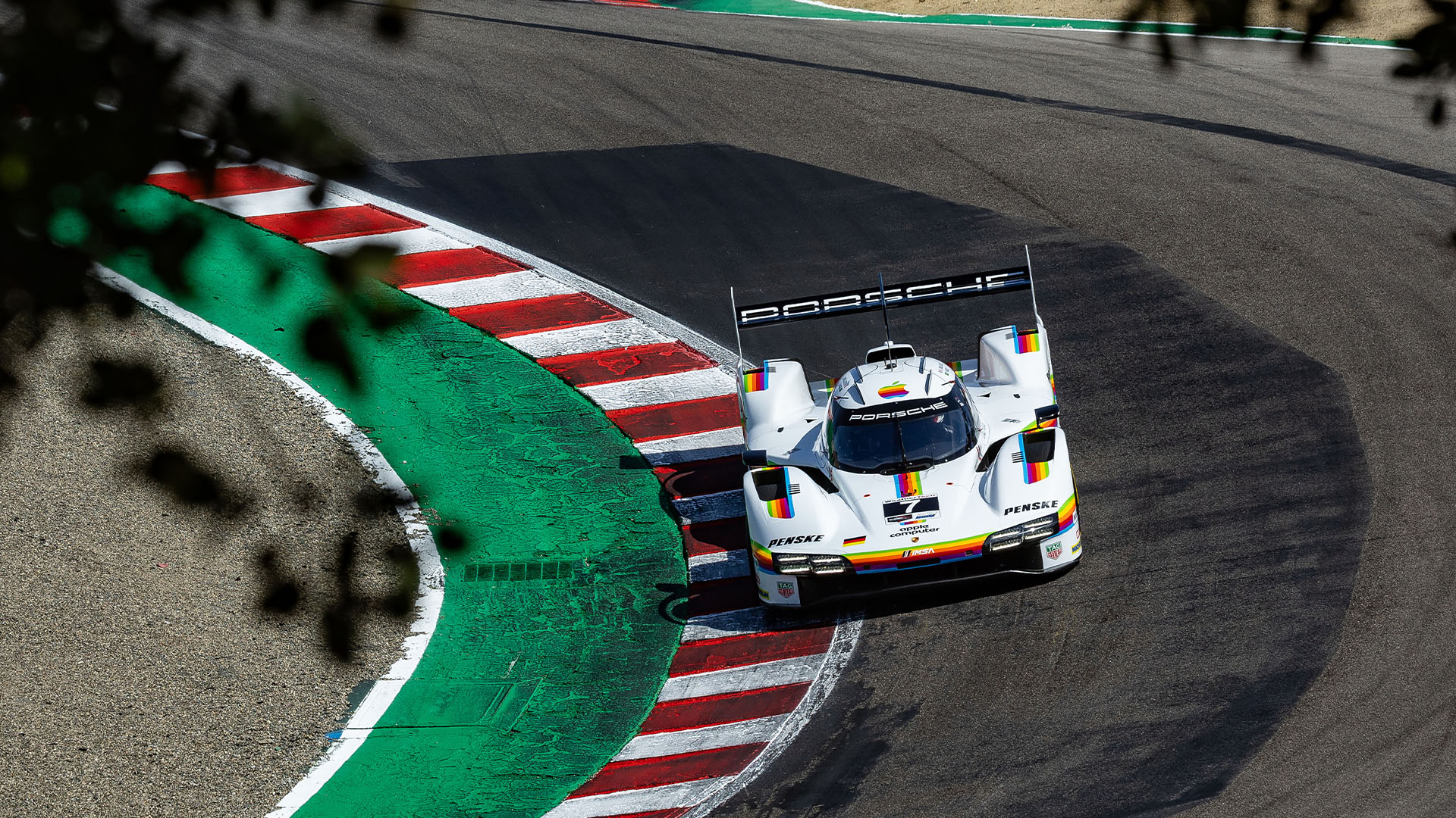 Image of Porsche Penske Motorsport 963 racecar wearing Apple Computer livery on the track at the 2026 IMSA WeatherTech Racew